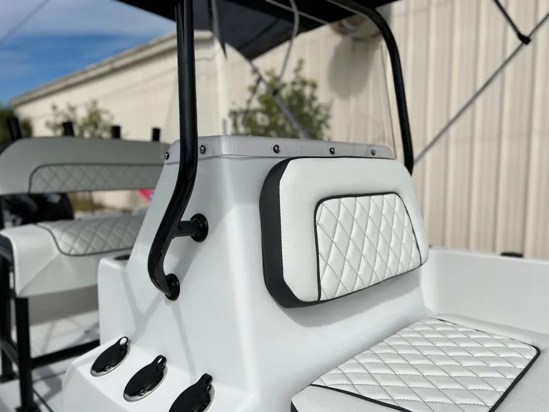 Slide: The Image of 2024 Clearwater 1900 boat interior with white quilted seats and black accents. - 15