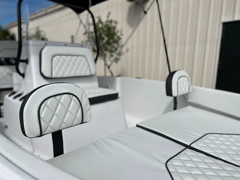 Slide: The Image of 2024 Clearwater 1900 boat interior with white quilted seats and backrests. - 16