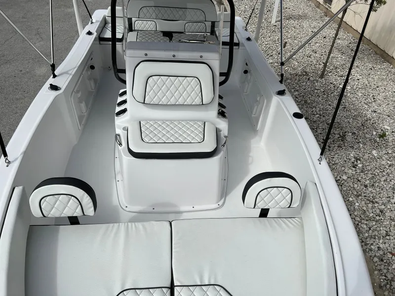 Slide: The Image of 2024 Clearwater 1900 boat interior with white cushioned seating and diamond stitching. - 26