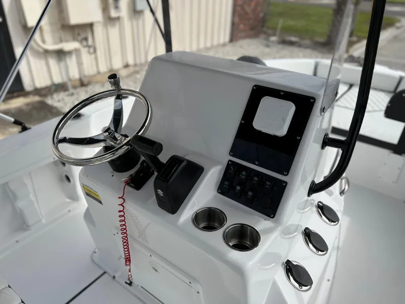 Slide: The Image of Clearwater 1900 boat console, 2024 model, featuring steering wheel and control panel. - 30