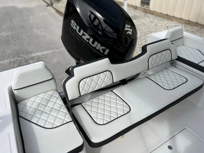 Slide: The Image of Clearwater 1900 2024 boat with Suzuki outboard motor and diamond-stitched seating. - 32