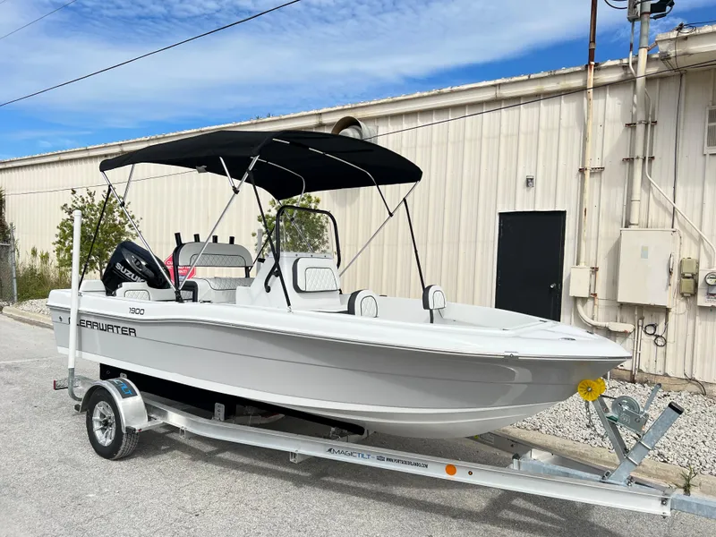 Slide: The Image of 2024 Clearwater 1900 boat on a trailer with a black canopy. - 5