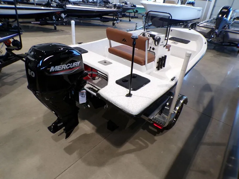 Slide: The Image of 2024 Skiff 160 PRO-Vee storage compartment with red safety equipment inside. - 15