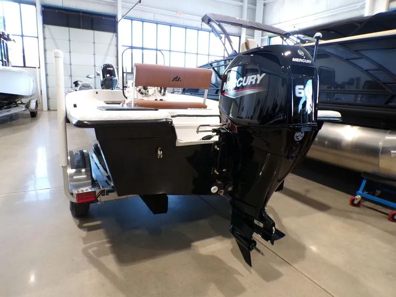 Slide: The Image of 2024 Skiff 160 PRO-Vee boat console with steering wheel and rod holders. - 16