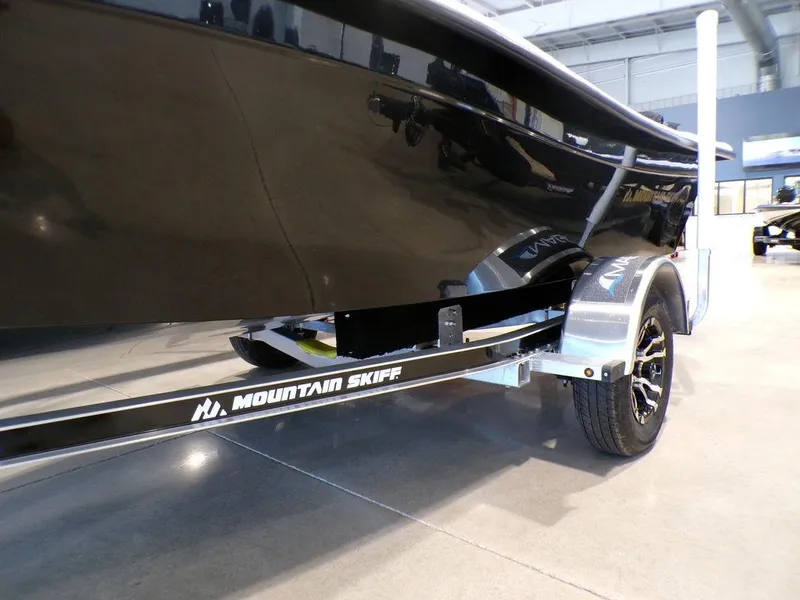 Slide: The Image of 2024 Skiff 160 PRO-Vee boat storage compartment with red fuel tank. - 19