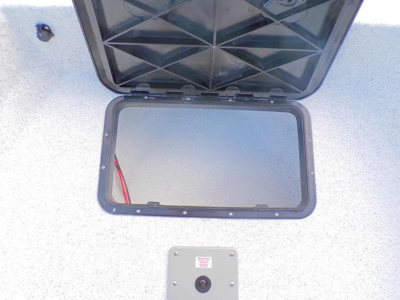 Slide: The Image of 2024 Skiff 160 PRO-Vee boat in a garage, featuring a clean interior and modern design. - 21