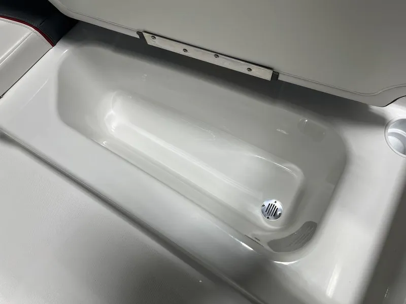 Slide: The Image of 2024 Tahoe T16 boat storage compartment with drain plug. - 18
