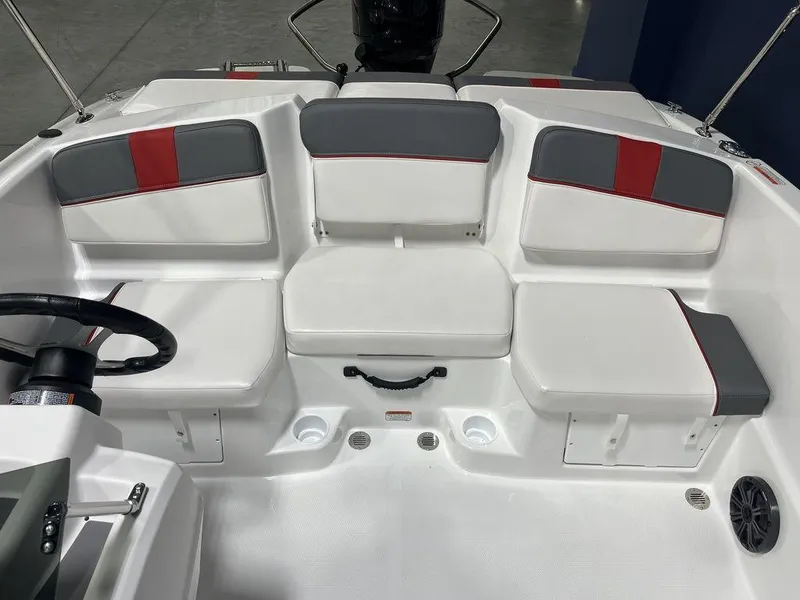 Slide: The Image of 2024 Tahoe T16 boat interior with white and gray seating, red accents, and steering wheel. - 19