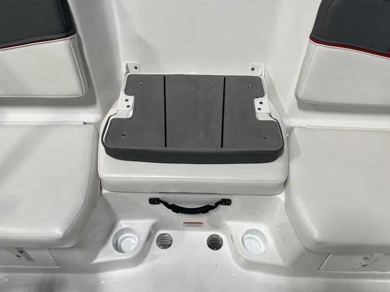 Slide: The Image of 2024 Tahoe T16 boat seating area with cup holders and storage compartment. - 23
