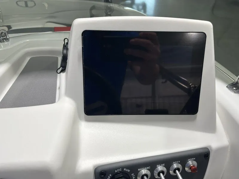 Slide: The Image of 2024 Tahoe T16 boat dashboard with touchscreen display and control switches. - 24