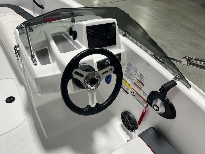 Slide: The Image of 2024 Tahoe T16 boat dashboard with steering wheel and control panel. - 25