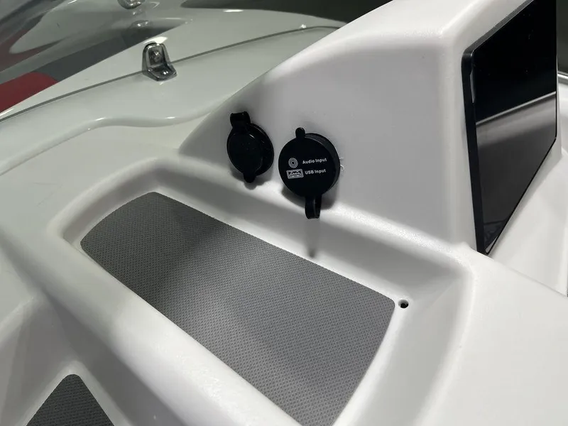 Slide: The Image of Close-up of the 2024 Tahoe T16 boat dashboard with USB ports. - 29