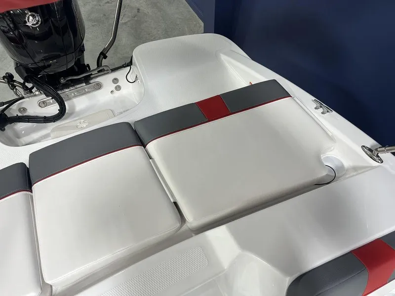 Slide: The Image of 2024 Tahoe T16 boat with cushioned seating and outboard motor. - 31