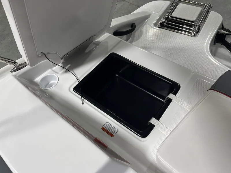 Slide: The Image of 2024 Tahoe T16 boat storage compartment with open lid and cup holder. - 32