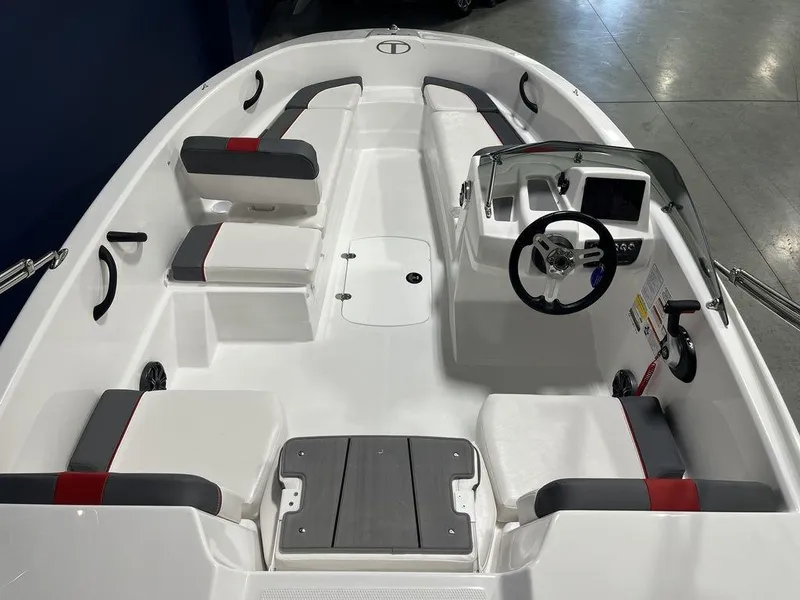 Slide: The Image of 2024 Tahoe T16 boat interior with seating, steering console, and storage compartments. - 8