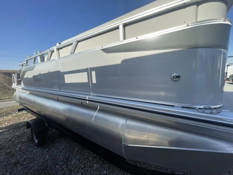 The Image of 2024 Tahoe STX CRUISE pontoon boat side view on trailer. - 1