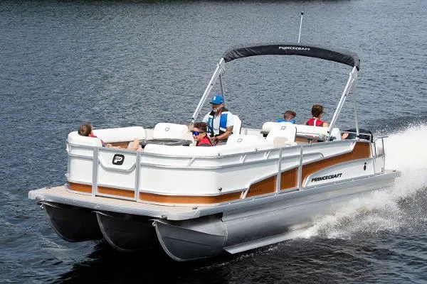 Slide: The Image of 2024 Princecraft Vectra 23 RL pontoon boat cruising on a lake with passengers. - 17