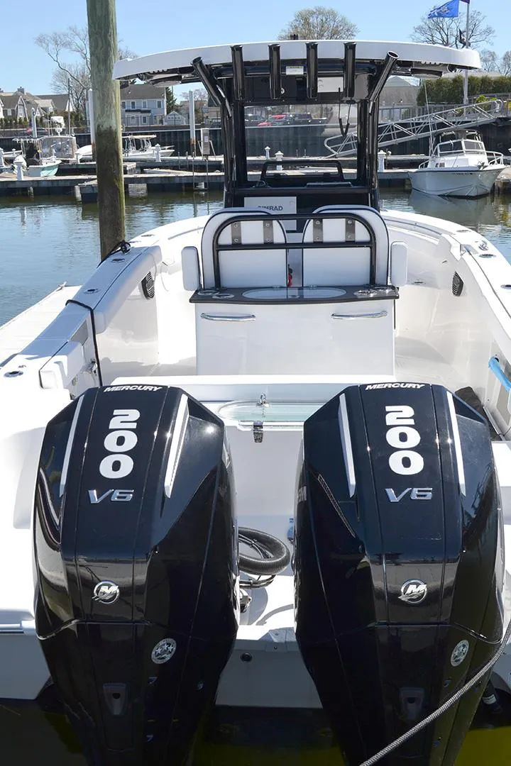 Slide: The Image of 2024 Sea Pro 262 DXL boat with dual 200 V6 engines docked at marina. - 9