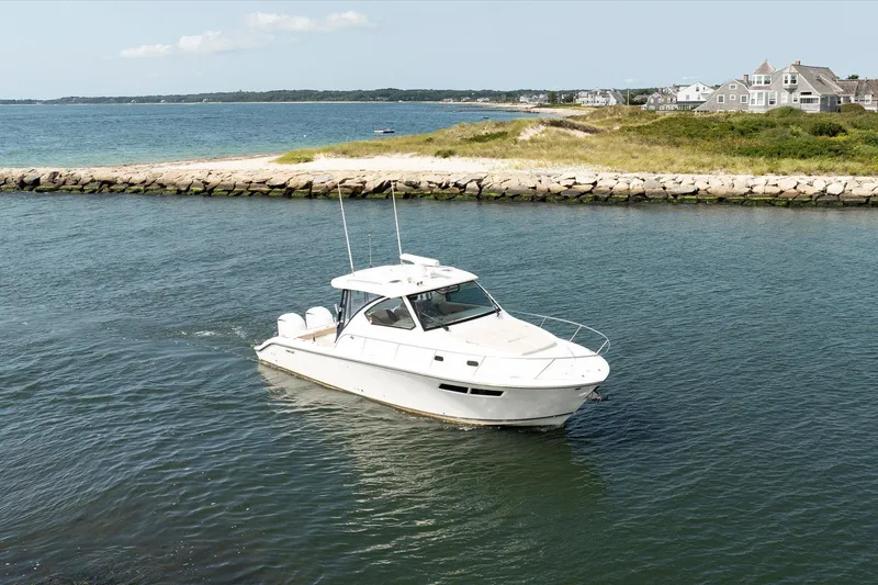 Slide: The Image of 2016 Pursuit OS 355 Offshore boat cruising in a scenic coastal waterway. - 1