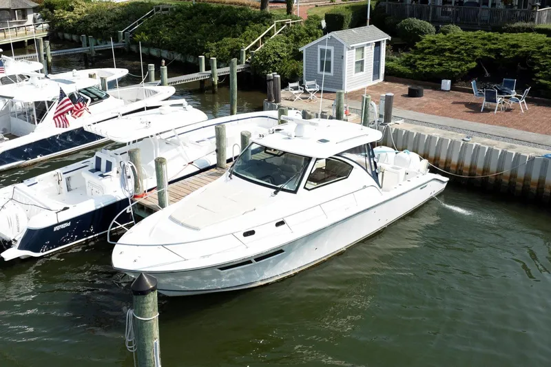 Slide: The Image of 2016 Pursuit OS 355 Offshore boat docked at marina. - 10