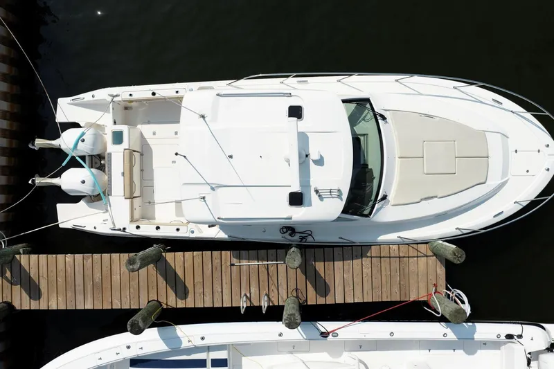 Slide: The Image of Aerial view of 2016 Pursuit OS 355 Offshore boat docked at a wooden pier. - 12