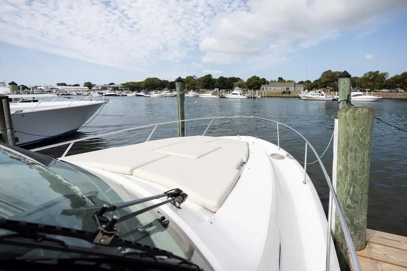 Slide: The Image of 2016 Pursuit OS 355 Offshore boat docked in a scenic marina. - 13