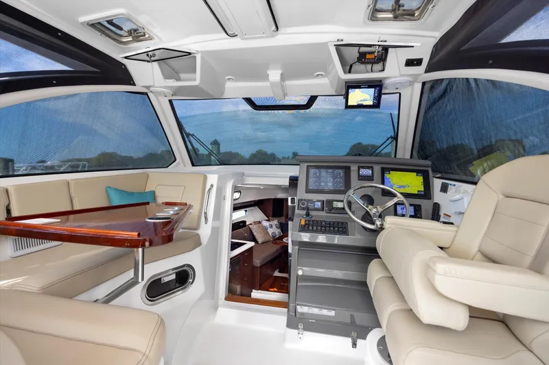 Slide: The Image of Luxurious interior of 2016 Pursuit OS 355 Offshore boat with modern helm and seating. - 15