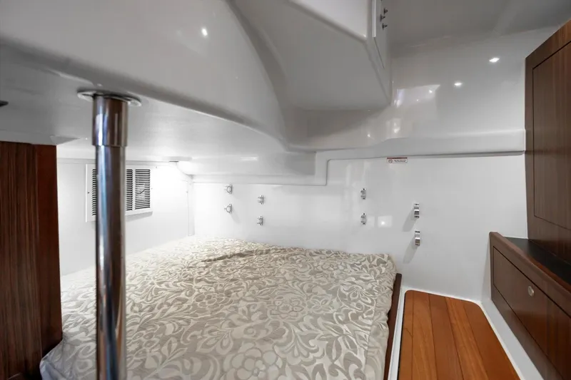 Slide: The Image of Interior cabin of 2016 Pursuit OS 355 Offshore boat with elegant bedding. - 20