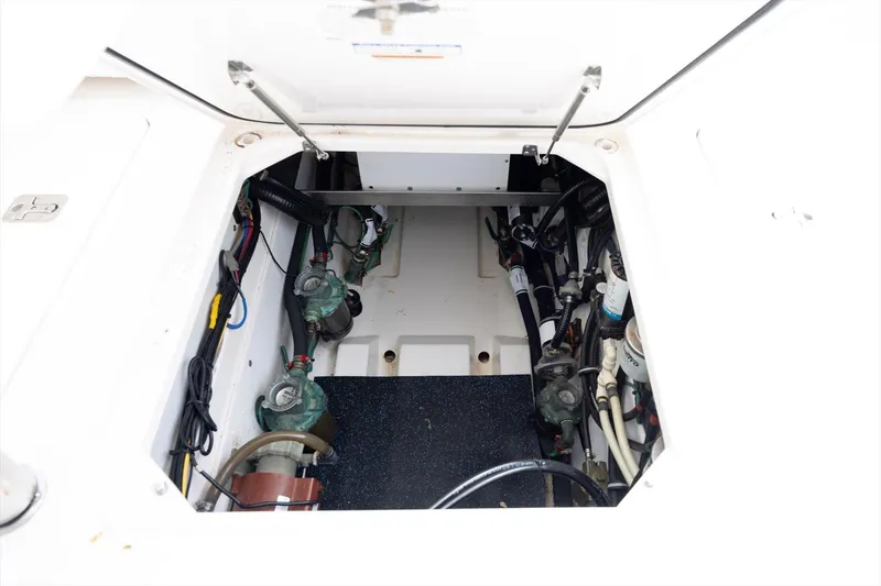 Slide: The Image of 2016 Pursuit OS 355 Offshore engine compartment with visible mechanical components. - 30