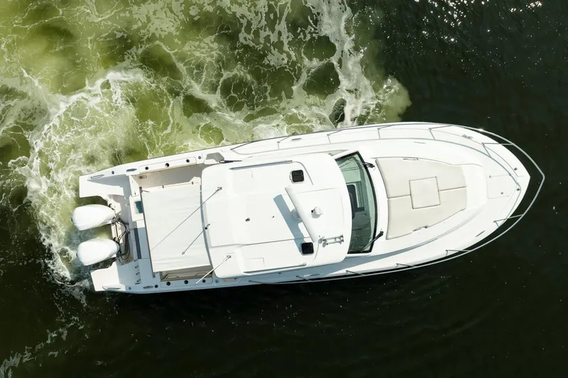 Slide: The Image of Aerial view of 2016 Pursuit OS 355 Offshore boat cruising on water. - 4