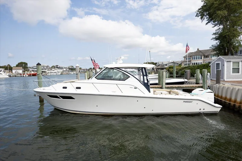 Slide: The Image of 2016 Pursuit OS 355 Offshore boat docked in a scenic marina. - 6
