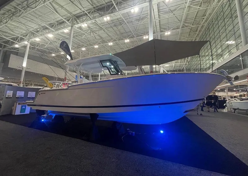 The Image of 2023 Bertram 28 CC boat displayed at an indoor boat show. - 0