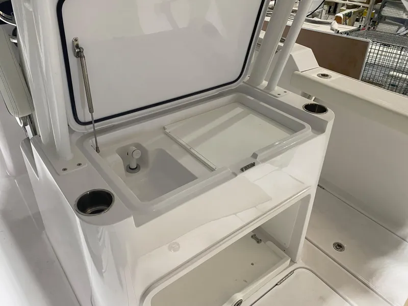 Slide: The Image of 2023 Bertram 28 CC boat with open storage compartment and cup holders. - 10