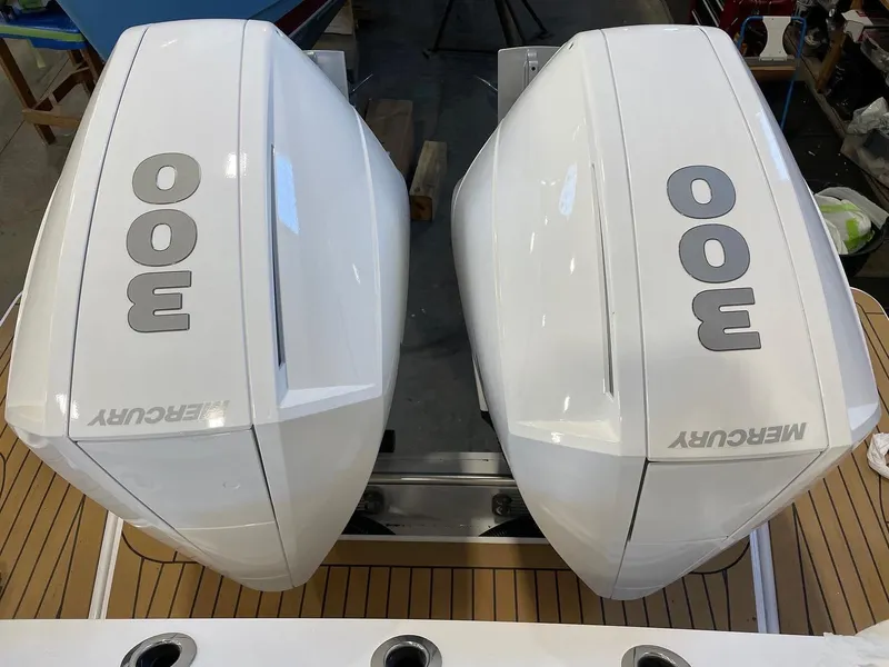 Slide: The Image of 2023 Bertram 28 CC with twin Mercury 300 outboard engines. - 12