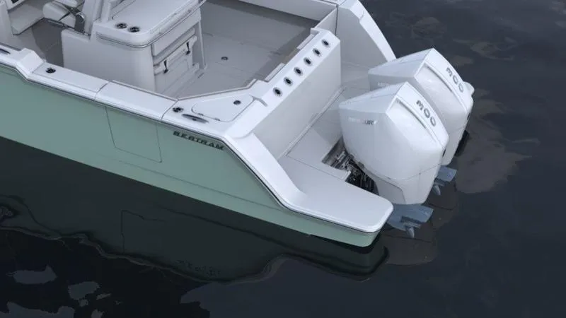 Slide: The Image of 2023 Bertram 28 CC boat with twin outboard engines on water. - 15