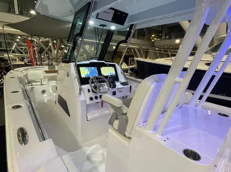 Slide: The Image of 2023 Bertram 28 CC center console boat interior with modern navigation system. - 2