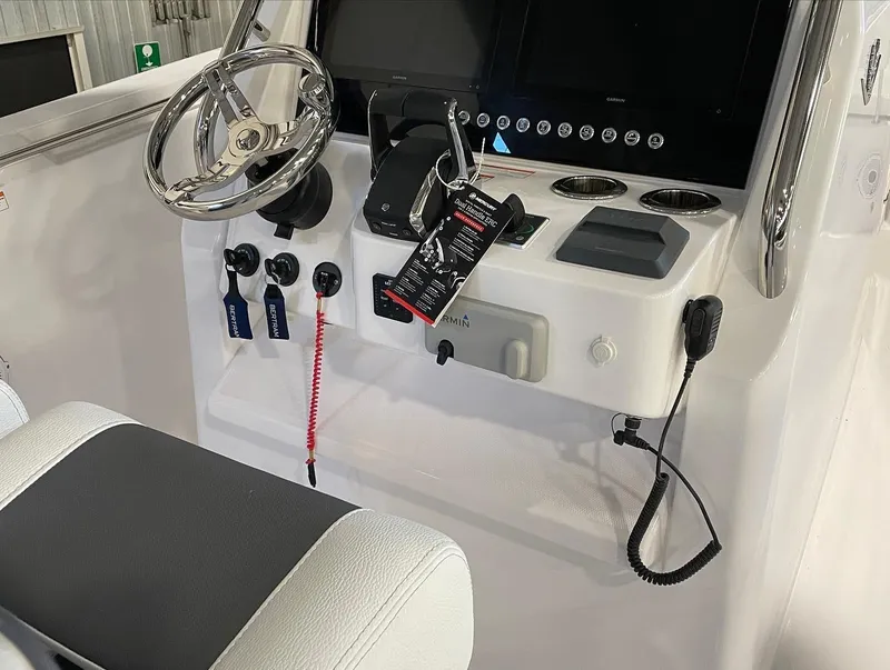 Slide: The Image of 2023 Bertram 28 CC boat console with steering wheel and controls. - 6