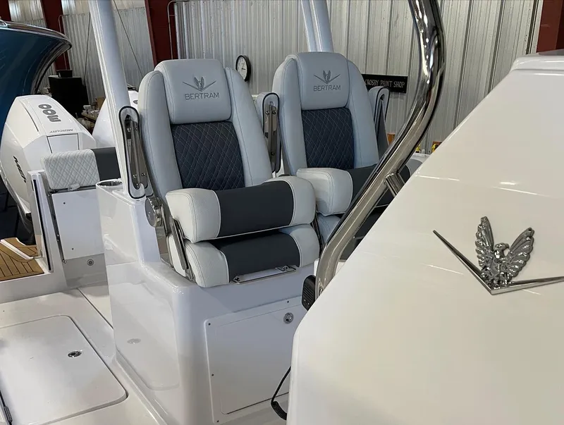 Slide: The Image of 2023 Bertram 28 CC boat interior with dual cushioned seats. - 7