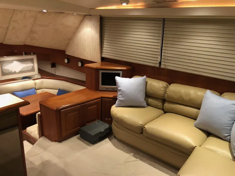 Slide: The Image of Luxurious interior of a 1990 Viking 38 Convertible yacht with beige leather seating. - 16