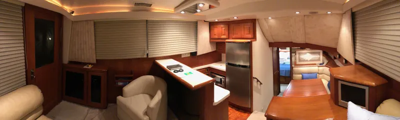 Slide: The Image of Interior of a 1990 Viking 38 Convertible yacht with modern kitchen and seating area. - 19