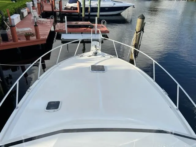 Slide: The Image of 1990 Viking 38 Convertible yacht docked at marina, view from bow. - 2