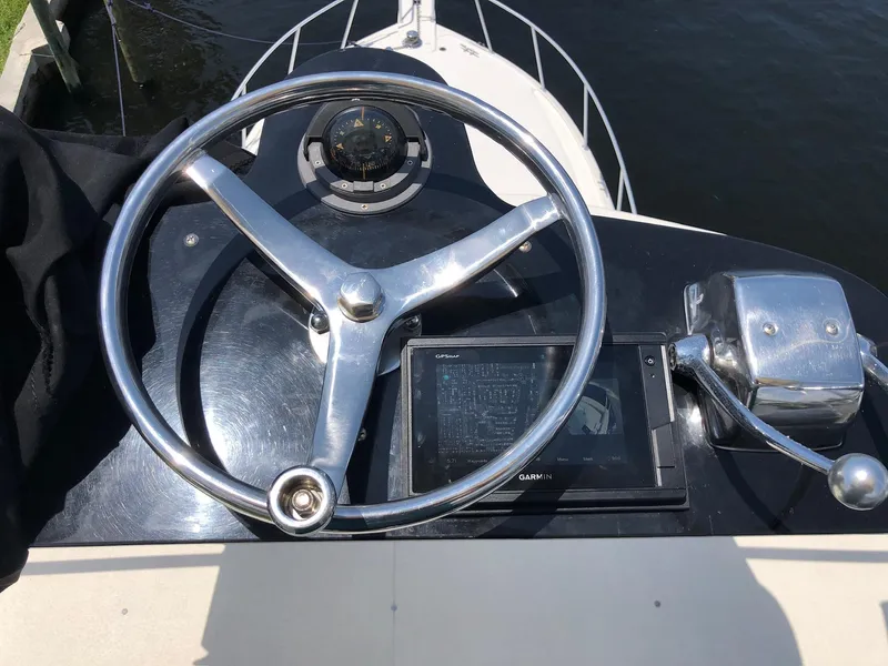 Slide: The Image of Steering wheel and controls of a 1990 Viking 38 Convertible boat. - 21