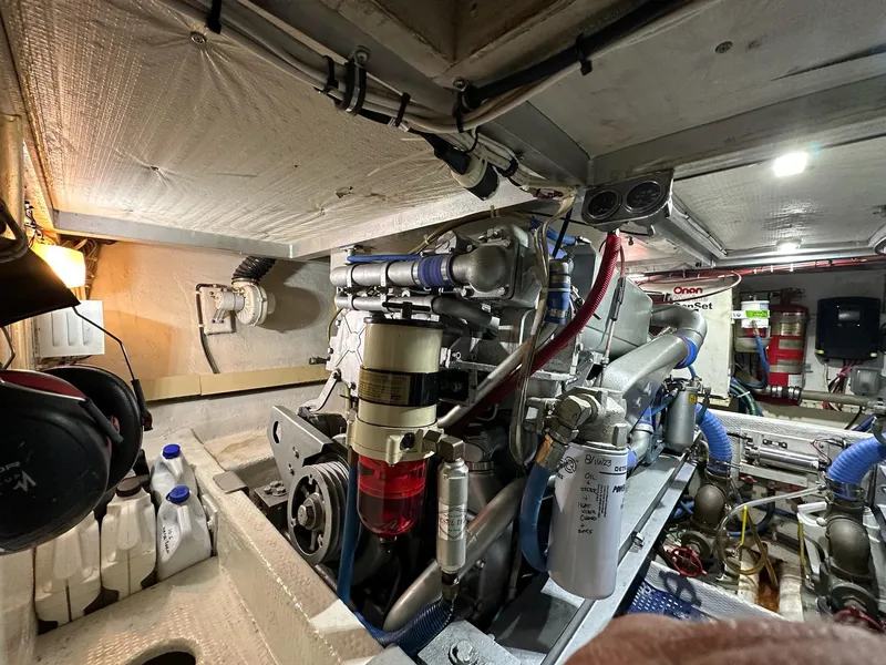 Slide: The Image of Engine room of a 1990 Viking 38 Convertible boat, showcasing mechanical components and equipment. - 25