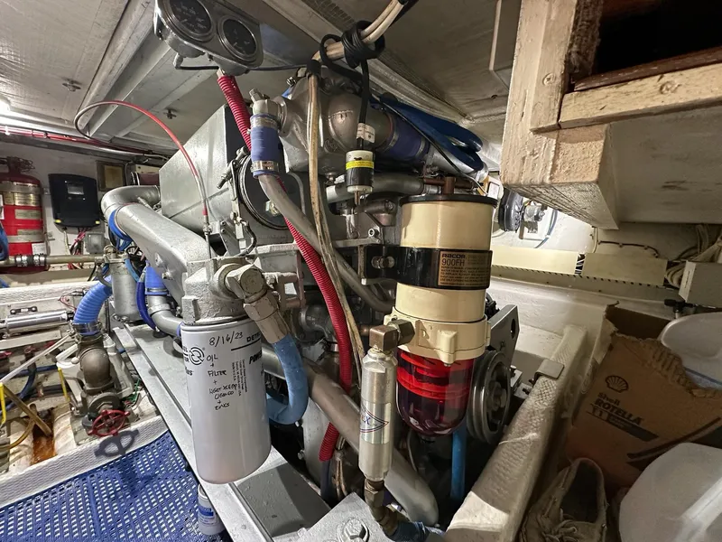 Slide: The Image of Engine room of a 1990 Viking 38 Convertible boat, showcasing detailed machinery and components. - 26