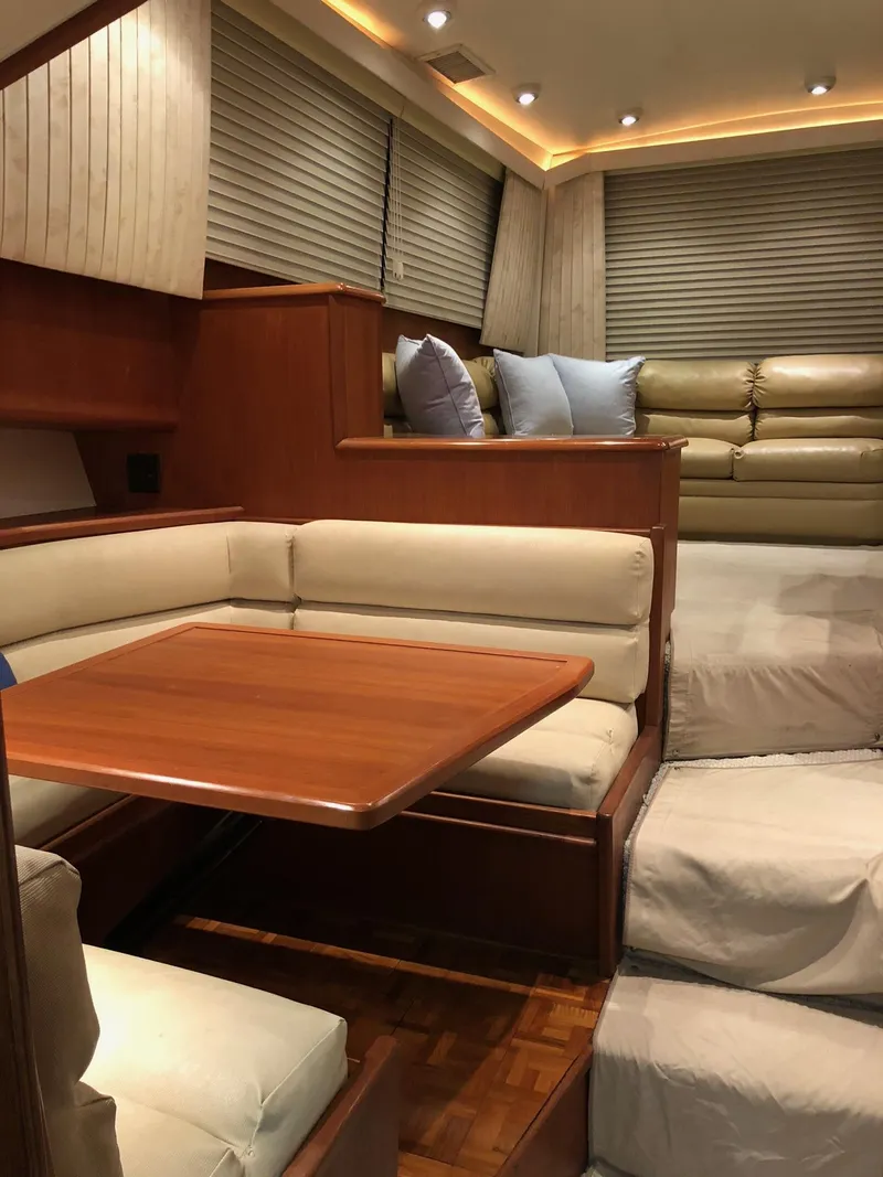 Slide: The Image of Interior of 1990 Viking 38 Convertible yacht with cozy seating and wooden table. - 9