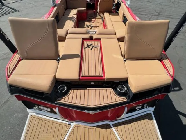 Slide: The Image of 2019 MasterCraft XT25 boat with tan seating and red accents. - 11