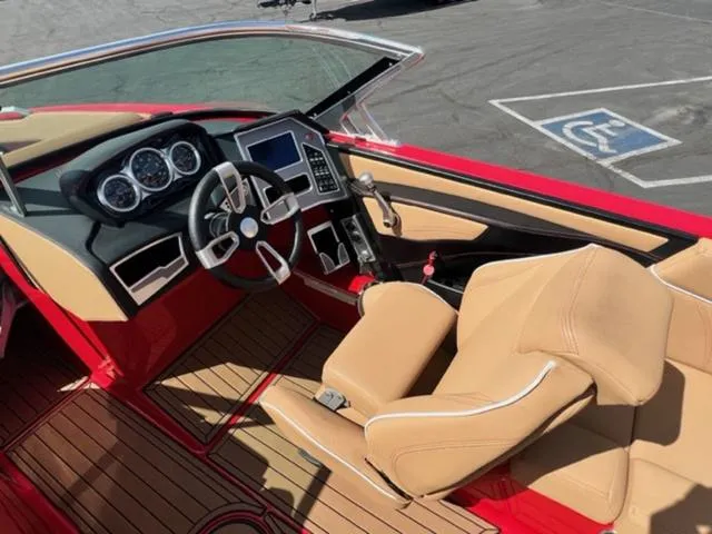 Slide: The Image of 2019 MasterCraft XT25 boat interior with tan seats and modern dashboard. - 13