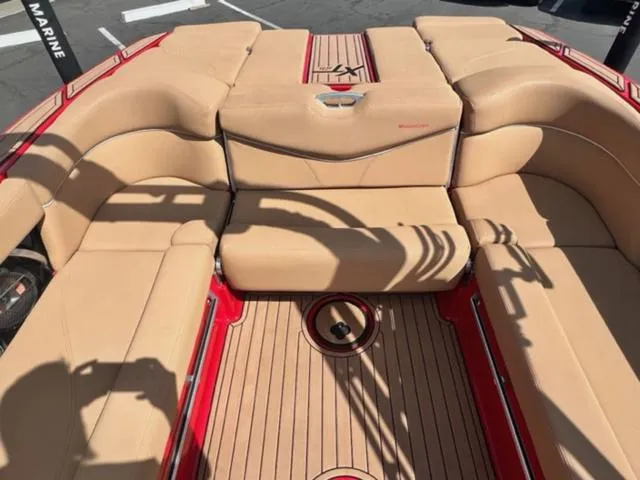 Slide: The Image of 2019 MasterCraft XT25 boat with tan seating and red accents. - 16