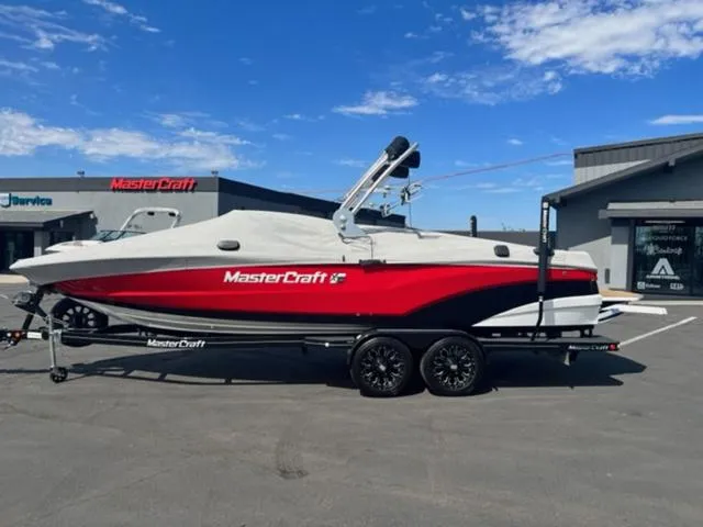 Slide: The Image of 2019 MasterCraft XT25 boat with red and white exterior on a trailer. - 22