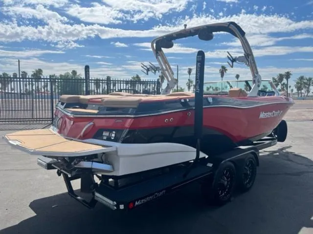 Slide: The Image of 2019 MasterCraft XT25 boat on trailer, red and black, with wakeboard tower. - 6